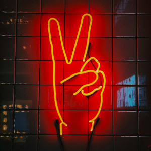 Neon peace fingers sign